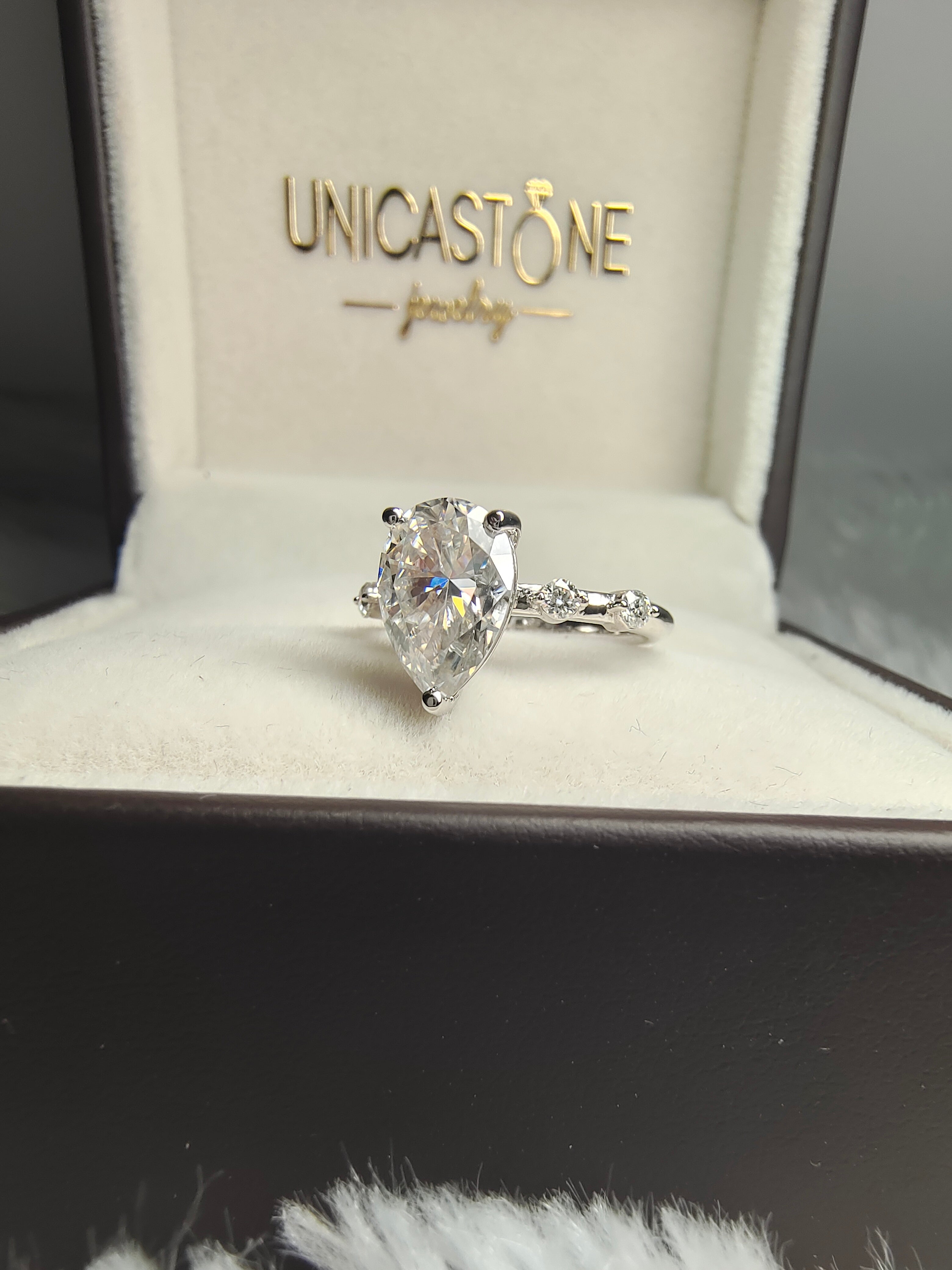 Unique Pear-Shaped Moissanite Diamond Engagement Ring with Side Stones Distance Pave Set in Gold Band